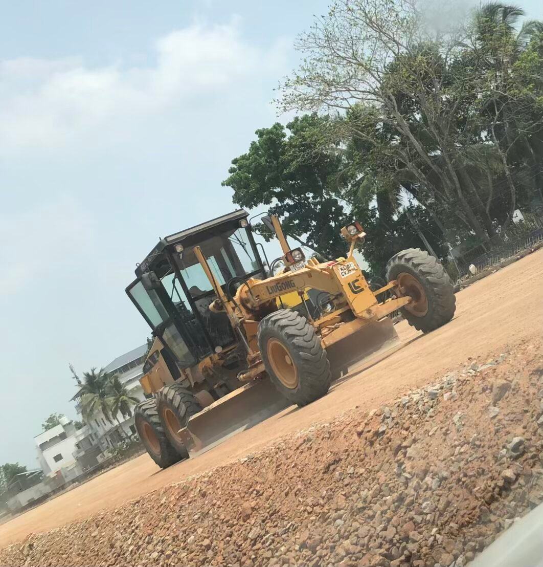 Motor grader levelling ground